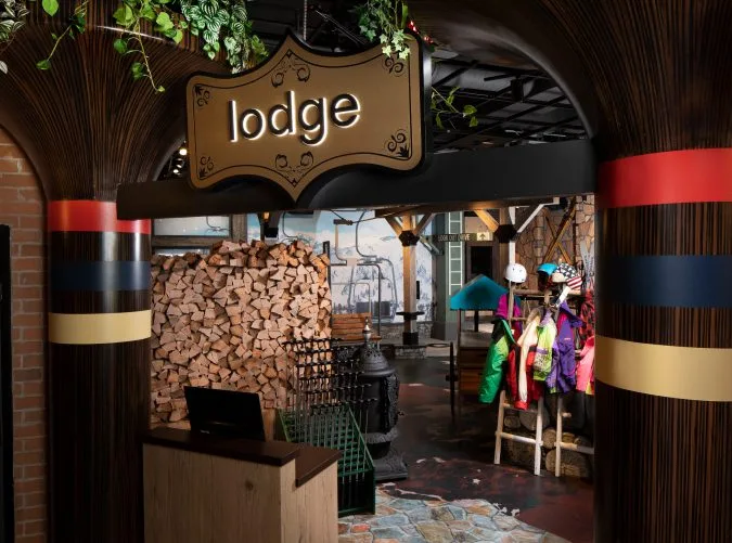 Frosty ski-themed mini-golf course featuring snow-covered displays and ski props.