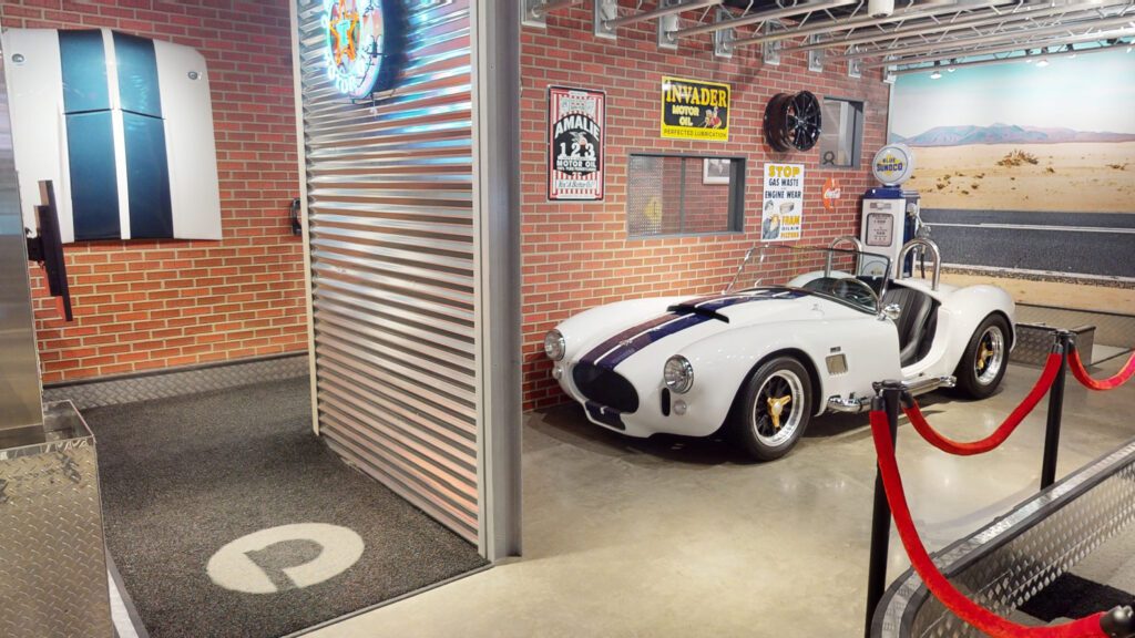 Garage-themed mini golf course at Puttery Pittsburgh with tire-wall decor, racing gear and metal ramps