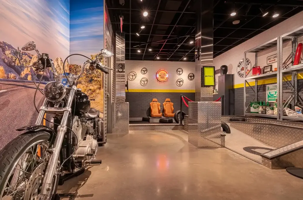 Motorcycle display and automotive-themed mini golf lane on the Garage Course at Puttery Pittsburgh.